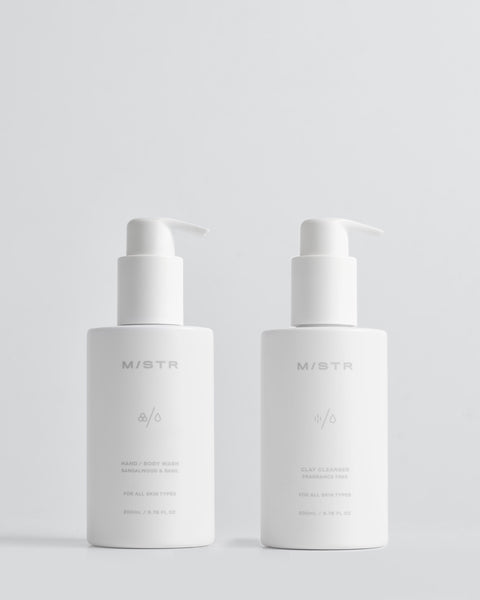 Two white skincare bottles with pump dispensers on a light gray background